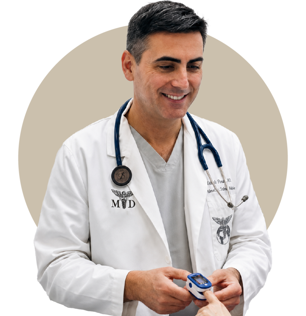 A smiling medical specialist wearing a white coat and stethoscope, demonstrating the use of an oximeter during a patient consultation at Posada Vida Health foundation.