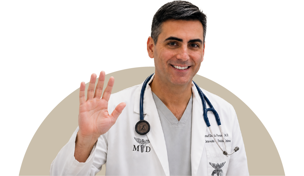 A friendly healthcare physician smiling and waving his hand in a welcoming gesture, wearing a white coat and stethoscope at Posada Vida Health foundation.